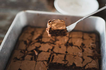 Best brownies dessert in a cake pan. High angle view of freshly baked brownies. Delicious chocolate...