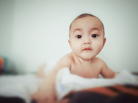 Portrait of curious looking baby kid with the big eyes.の写真素材
