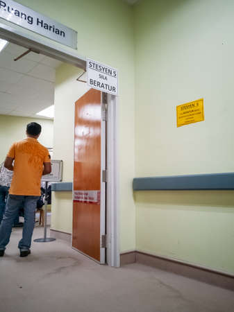 Selangor, Malaysia - July 6, 2021: Signage to queue written in Malay hanging at the Serdang Hospital...