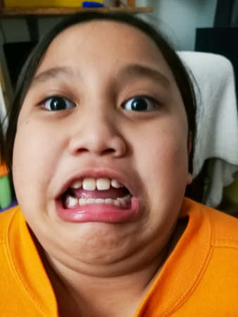 Blurry photo of a girl making funny face.