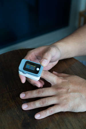 Pulse oximeter used to measure pulse rate and oxygen levelsの写真素材