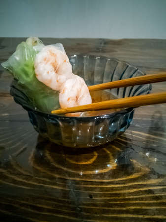 Traditional vietnamese spring rolls with shrimps, carrots, cucumber, green onions and rice noodles.の写真素材