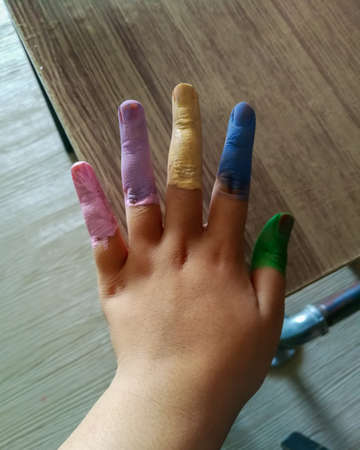 Colourful child's painted fingers. Top view.の写真素材