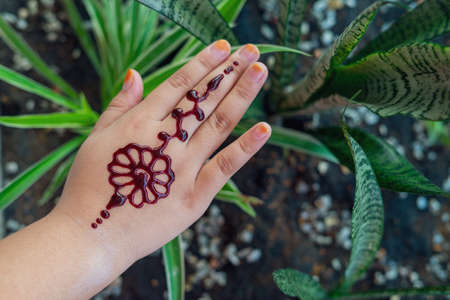 Henna ornaments on little girl's hand closeup.の写真素材