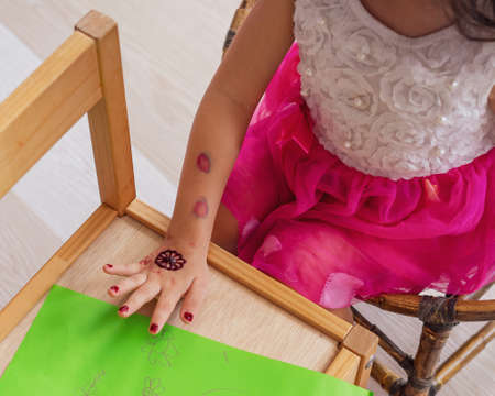 Henna ornaments on little girl's hand closeup.の写真素材
