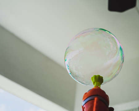 A large soap bubble is blowing up from the fish blower.