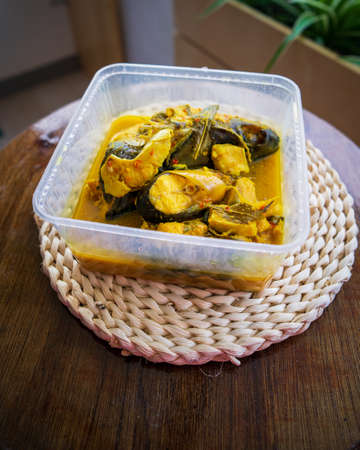 River Fish Pangasius Sutchi, Malaysia Tradisional Food 'Ikan Patin Tempoyak' in a takeaway container.の写真素材