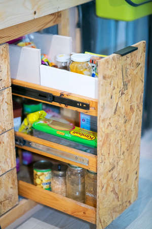 Kuala Lumpur, Malaysia - July 11, 2021 Pantry with pull out shelves full with food.のeditorial素材