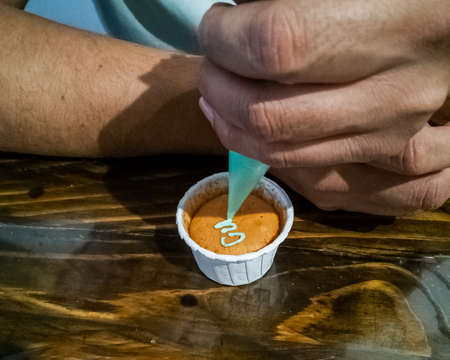 Decorating cupcake on a wooden table.の写真素材