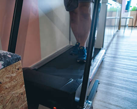 Motion of a Man running in a gym on a treadmill concept for exercising, fitness and healthy...