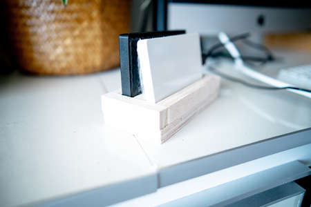 External hard disk for backup files on a wooden stand. Working with computers.