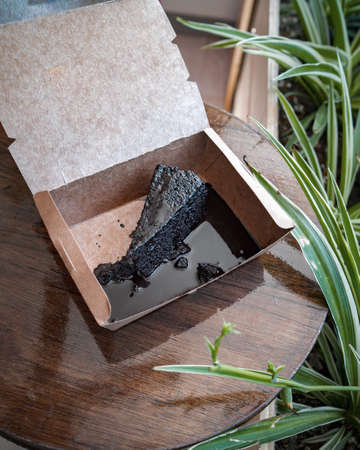 Chocolate cake slice, a cut piece on a table of a cafe restaurant.