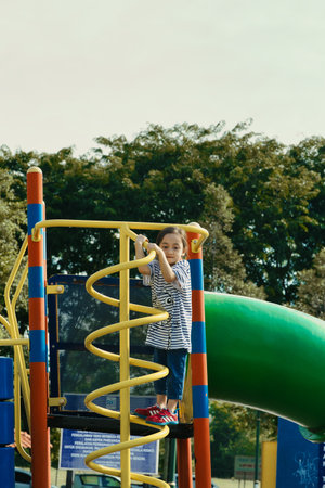Bangi, Malaysia - September 18, 2021 Little girl playing at the playground.