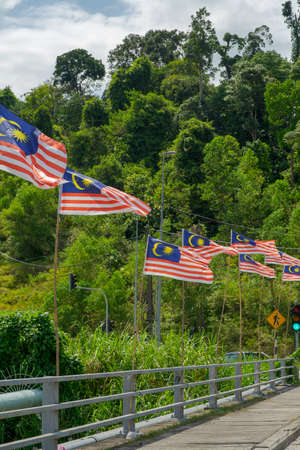 Malaysia flags waving near the bridge.