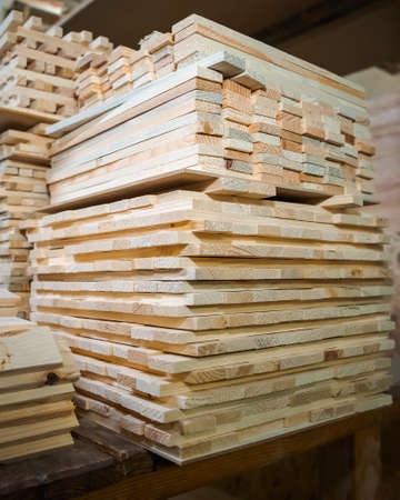 Pine wooden bar blocks materials stacked at carpentry woodwork workshop. Timber wood blanks at diy workbench. Close-up. Handcraft hobbyの写真素材