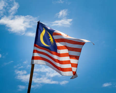Malaysia flag waving against blue skies.の写真素材