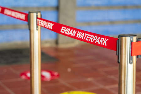 Port Dickson, Malaysia - Nov 19, 2021:   Ehsan Water park stainless steel with red line barricade.のeditorial素材