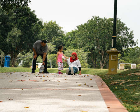 Bangi, Malaysia - Oct 16, 2021 Children riding skateboard and scooter in the park.