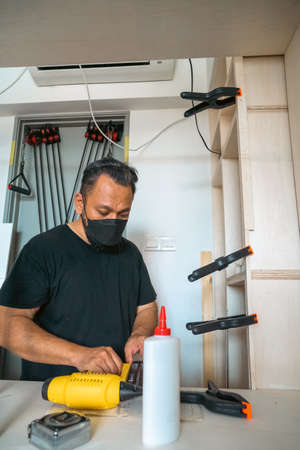 Man DIY wood project at home.