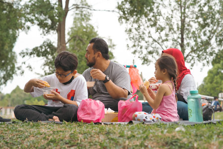 Bangi, Malaysia - Oct 16, 2021 Family picnic and eating at the park.のeditorial素材