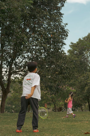 Bangi, Malaysia - Oct 16, 2021 Young Asian children playing badminton at the park.のeditorial素材