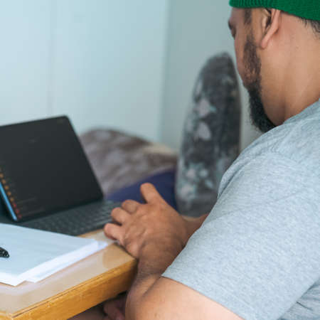 Entrepreneur working with a laptop and document in a little office or home.の写真素材