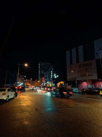 Terengganu, Malaysia - May 11, 2022: Busy road in the city after rain at night.のeditorial素材