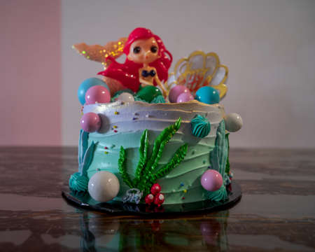 Underwater mermaid cake on the wooden table.の写真素材