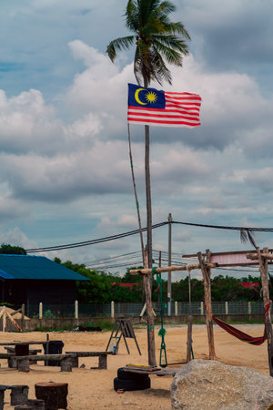 Malaysian flag waving near the beach on a village.のeditorial素材