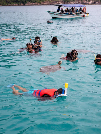Redang, Malaysia - May 11, 2022 : Group of tourists are snorkeling together with the turtles in Pulau Redang.のeditorial素材
