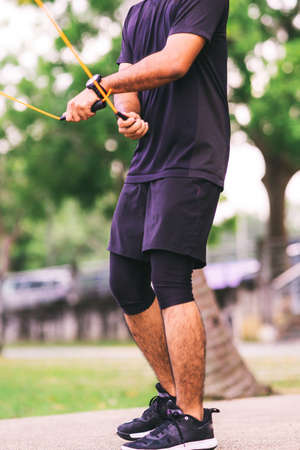 Man using jumping rope outdoors. Copy space.の写真素材
