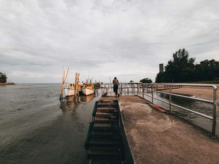 Sunset time at the jetty near the fisherman village with full of boats.の写真素材