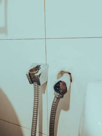 Dirty stainless steel hand bidet in a bathroom.の写真素材