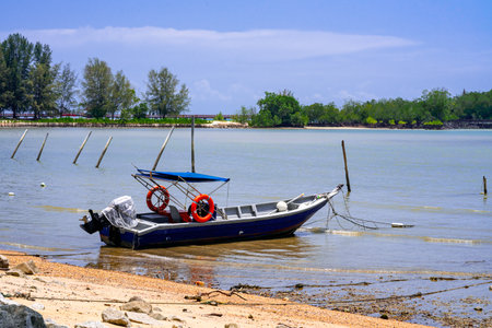 Fisherman boat anchored at the beach on a sunny day.のeditorial素材