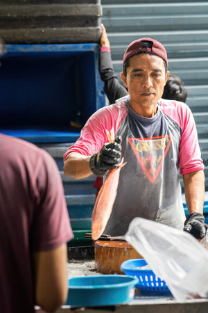 Sekinchan, Malaysia - Oct 6, 2022 Fishermans transferring out the fish catch into the containers.のeditorial素材
