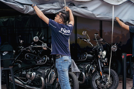 Terengganu, Malaysia - June 26, 2022 : Worker opening a stall during the Bike Week event.のeditorial素材