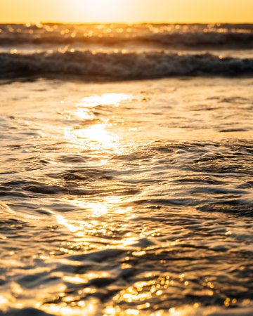 Beautiful view of the sea waves during golden sunset.の写真素材