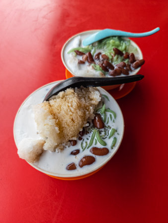 Malaysia traditional iced sweet dessert Cendol served in a bowl with glutinous rice, coconut milk and red beans.の写真素材