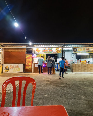 Bangi, Malaysia - July 12, 2022 People at the Nasi Lemak stall buying dinner.のeditorial素材