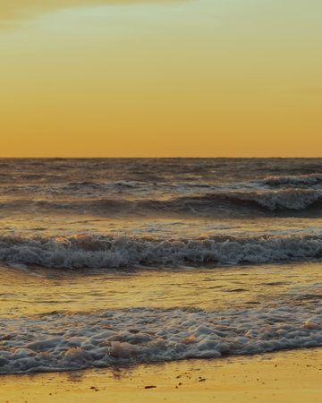 Beautiful view of the sea waves during golden sunset. Close-up.の写真素材