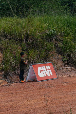 Pahang, Malaysia - Sept 24, 2022 A young cameraman is waiting at the enduro race finish line.のeditorial素材
