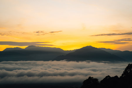 Golden sunrise above the Titiwangsa range mountains surrounded by the sea of clouds in Lenggong,...