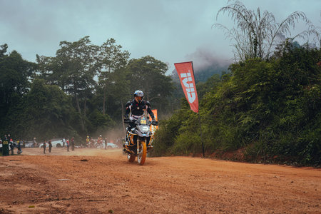 Pahang, Malaysia - Sept 24, 2022 Enduro bike rider on action on the sand terrain during practice.のeditorial素材