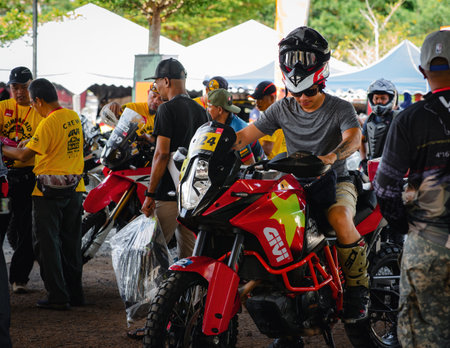 Pahang, Malaysia - Sept 24, 2022 Enduro motorcyclists checking their vehicles during practice.
