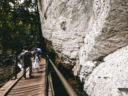 Family walking near the Gua Kelam or Kelam cave near the rainforest jungle in Perlis, Malaysia.のeditorial素材