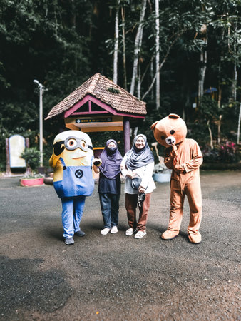Perlis, Malaysia - Aug 6, 2022; Hijab women with two mascots at the entrance of Gua Kelam or cave or darkness entrance.のeditorial素材