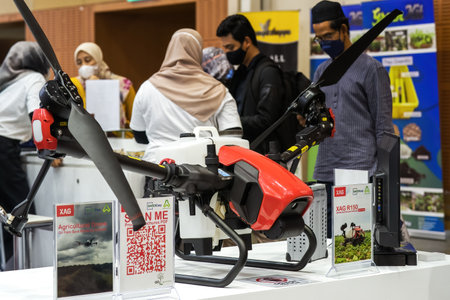 Putrajaya, Malaysia - Aug 10, 2022 Modern technologies in agriculture. An industrial drone used to sprays useful pesticides to increase productivity and destroys harmful insects at the MAHA expo.のeditorial素材