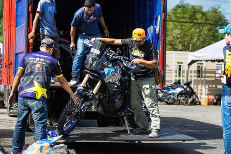 Pahang, Malaysia - Sept 24, 2022 Motorcross motorcycle on the truck and people unloading in the background.のeditorial素材