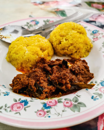Decorative traditional Malaysia and Indonesia food,  beef "rendang" with Yellow Glutinous Rice also known as "Pulut Kuning".の写真素材