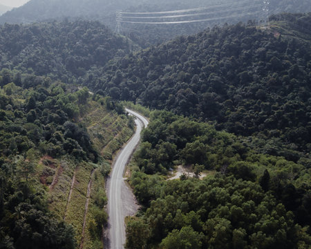 An aerial view of the road across the rainforest mountains in Hulu Selangor, Malaysia.の写真素材